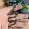 Detailed close-up of textured snake scales on a vintage solid brass cobra figurine - S-shaped Snake (Bronze Antique)