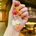 Close-up of a conch-shaped acrylic keychain featuring natural shells and orange sand - Conch Pendant (Colored Buckle) / Orange