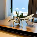 Artistic bronze mantis figurine with detailed wings on a wooden table for home decor - Gold Praying Mantis