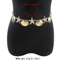 Detail view of a gold starfish and shell body chain waist jewelry on a black mannequin - Starfish and Shell Style / Gold