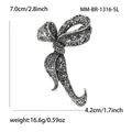 Vintage silver bow brooch with black rhinestones and intricate hollow patterns - Antique Silver Black Rhinestone