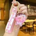Pink lollipop keychain with cherry blossom sequins and glitter inside a sand bottle - Pink Glow-in-the-dark Bean Cheese Sticks