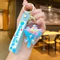 Blue cherry blossom floating liquid keychain with Good Luck strap and macaron beads - Blue Glow-in-the-dark Bean Cheese Sticks