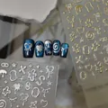Golden and silver 3D embossed nail stickers with stars and metallic fluid designs - Metal Relief Interlocking Letters Style (CO-604 Silver Stamping)