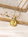 Macro view of gold-plated coin necklace featuring Elizabeth II portrait on stone background - Queen Portrait Coin Pendant