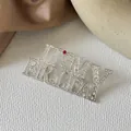Detailed view of rhinestone IT'S MY BIRTHDAY brooch with silver finish and red crystal accent - It's My Birthday Brooch - Silver (XZ1500)