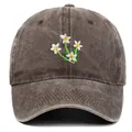 Close-up of vintage washed dark brown cotton baseball cap with detailed floral embroidery - One Size / Coffee