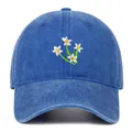 Close-up of detailed white flower embroidery on a washed navy blue baseball cap - One Size / Dark Blue