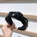 Fashionable black knotted wide headband featuring premium faux leather texture and cross design - Leather Black