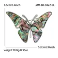 Elegante broche de mariposa con alas de nácar natural y brillantes pedrería - Plateado