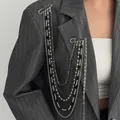 Detail of multi-layered silver and black bead chain brooch with star pins on suit - Silver With Black And Silver Layered Chains