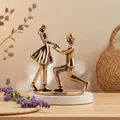 Macro detail of bronze kissing couple statue on a smooth white base for home decor - Proposal Ornament