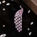 Elegant peacock brooch with pink crystal gradient and silver chain tassels on black velvet - Pink