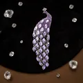 Peacock brooch with purple rhinestones and silver tassels on black velvet backdrop - Taro Purple