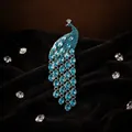 Elegant peacock brooch with blue teardrop crystals and silver-tone diamond setting - Lake Blue