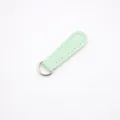 Detailed view of mint green PU leather zipper puller with fine white stitching - Long Light Green Silver Buckle