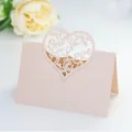 Macro detail of laser-cut One Love heart table card with peach pearlescent texture - Light Peach Striped