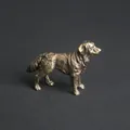 Macro detail of vintage brass dog figurine showing intricate carved fur texture - Border Collie