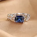 Close-up of Cuban link ring with a large rectangular blue zircon and silver finish - US 6 / Silver with Blue Stone