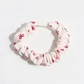 Beige scrunchie with red bow pattern and elastic core for gentle hair styling - Bow Scrunchie / Beige Bow Print