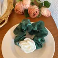 Elegant dark green satin scrunchie featuring a white fabric camellia flower decoration - Camellia Hair Tie / Dark Green Camellia