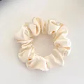 Elastic satin scrunchie in creamy white finish with smooth pleated fabric texture - Scrunchie / Satin Off-White