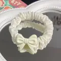 Elegant white satin scrunchie featuring a matte bow on a creative mirror background - Bow Scrunchie / Off White
