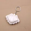 Detailed view of a white leather seashell pendant with metallic pearl finish and silver ring - Pearlescent Silver White