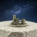 Macro detail of a bronze pagoda miniature on a natural rock with a starry galaxy background - Castle