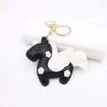 Detailed view of handmade black leather Pegasus bag charm with white wing accents - Black Unicorn Pegasus