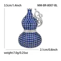 Dimensiones detalladas del broche hulu de cristal azul con 3,5 cm de alto y 2,1 cm de ancho - Paladio Blanco K-blue 8007-bl