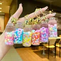 Close-up of colorful liquid drifting bottle keychains with glitter and gold metal rings - Nocturnal Snowflake High Bottle (Gold Hardware) / Lobster Clasp Style / Multicolor