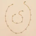 Macro shot of stainless steel necklace and bracelet set with crystal flower charms - Transparent White Necklace And Bracelet