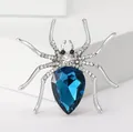Close-up of spider brooch with blue pear-cut crystal and silver alloy rhinestone setting - Silver and Blue Spider Style
