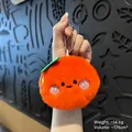 Plush orange fruit keychain with cute smiling face and green leaf for bags - Persimmon