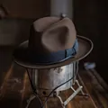 Classic dark brown wool fedora with black grosgrain ribbon on vintage stand - Coffee