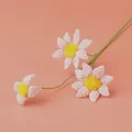 Handmade crochet daisy flowers in light pink with three heads on a pink background - Blue-Eyed Daisy Branch - Pink