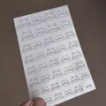 Detailed view of F-12 silver cat head hollow nail art stickers on a transparent sheet - Cat Head Line Style (F-12)