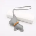 Close-up of gray leather French Bulldog bag charm with stitching and gold buckle - Gray