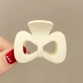 Chic cream white bow hair claw clip with a matte finish for ponytail styling - Hollow Bowknot / Cream White