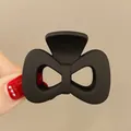 Matte black bow-shaped hair claw clip for high ponytail, sleek minimalist hair accessory - Hollow Bowknot / Matte Black