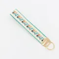 Ethnic floral embroidered keychain with cream woven strap and gold metal clasp - Cream Colorful Floral Embroidery (09-06G)