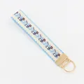 Ethnic floral embroidered fabric wristlet keychain with golden metal ring and blue edging - Purple Flower Blue Leaf Blue Wave Edge (09-06H)