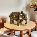 Detailed close-up of a vintage bronze mammoth figurine with an antique textured finish - Small Elephant Ornament / Bronze