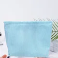 Blue and white striped seersucker makeup bag with a metal zipper for travel use - Mint Green