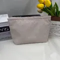 Seersucker cosmetic bag with brown stripes and a textured seersucker finish - Khaki
