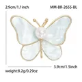 Broche de mariposa dorada con alas de mármol azul y perla central, talla 3,9x2,9cm - Azul Dorado