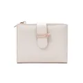 Detail of off-white short wallet with cross-grain texture and gold bow buckle - Beige
