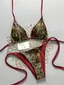 Two-piece leopard print bikini set with vibrant red lining and adjustable side ties - Zebra Flower