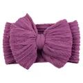 Elastic deep purple baby headband with a large knitted bow and ribbed texture - Deep purple